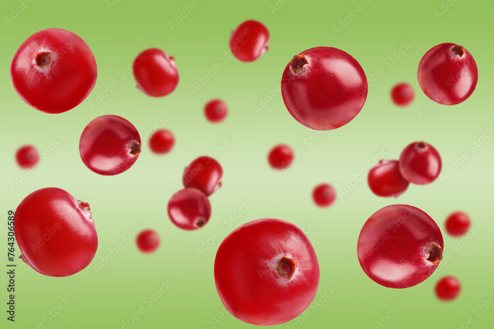 Fresh red cranberries falling on green background Fresh red cranberries falling on green background