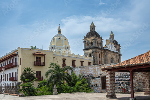 Cartagena, Colombia - July 25, 2023: Santuario de San Pedro Claver church towers, historic front facade seen from Baluarte de San Ignacio bastion under blue cloudscape photo