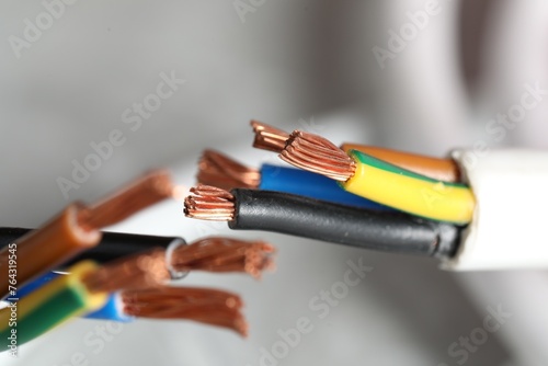 Colorful electrical wires on blurred background, closeup
