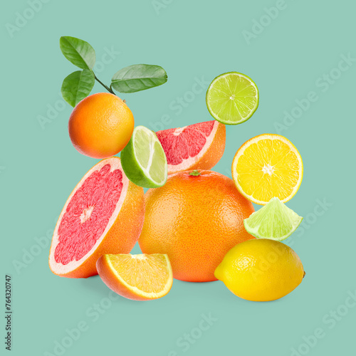 Stack of different citrus fruits on light blue background