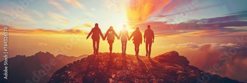 Group of people standing on top of a mountain with the sun setting behind them. Generative AI.