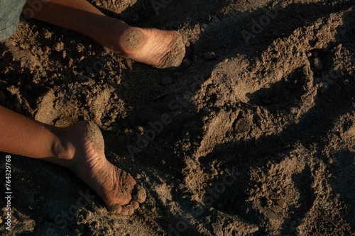 Kid's feet on the sand