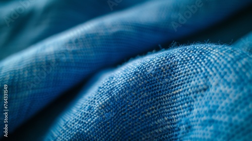 This detailed closeup showcases the stunning texture of blue linen fabric, featuring creased folds and a soft, slightly napped finish. Perfect for clothing, curtains, bedding, and more.