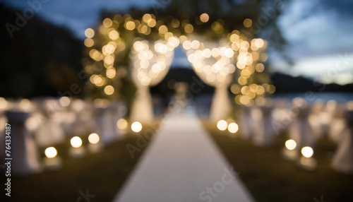 A blurred focus empty wedding venue with bokeh lighting and white decorations