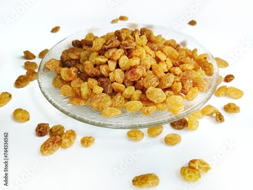 Currant fruit on a white background. Pile the dried raisins on a clear plate 