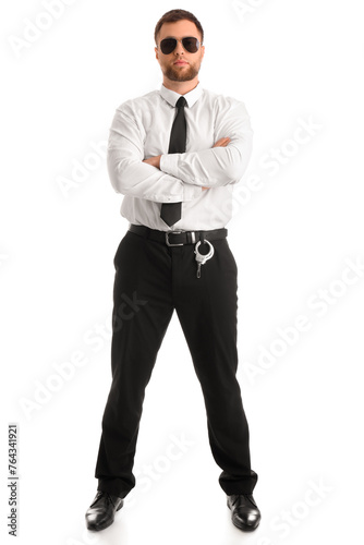 Male police officer with crossed arms on white background © Pixel-Shot