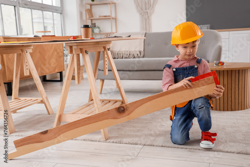 Cute little builder measuri...