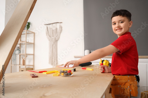 Cute little builder at tabl...