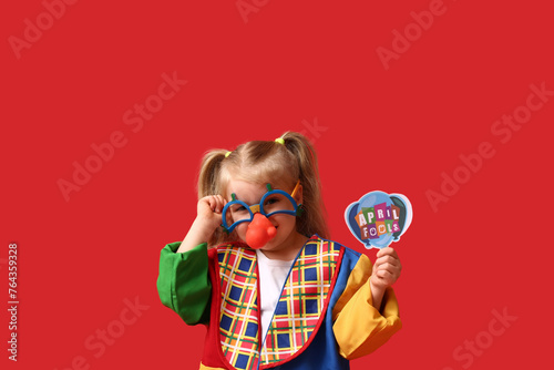 Little girl in clown costum...