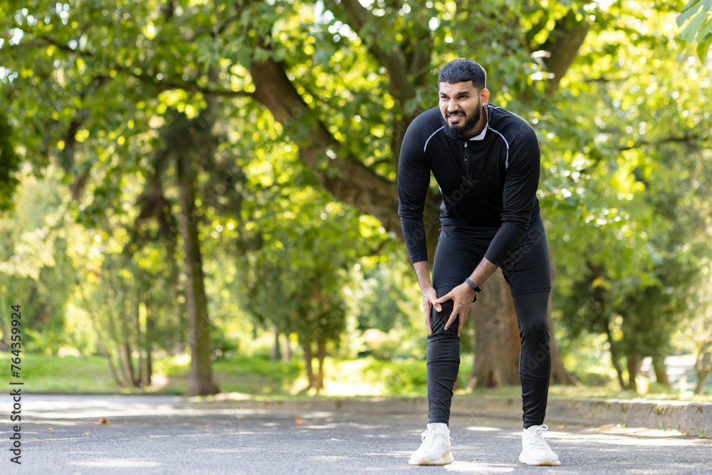Athlete experiencing knee pain during outdoor workout Athlete experiencing knee pain during outdoor workout