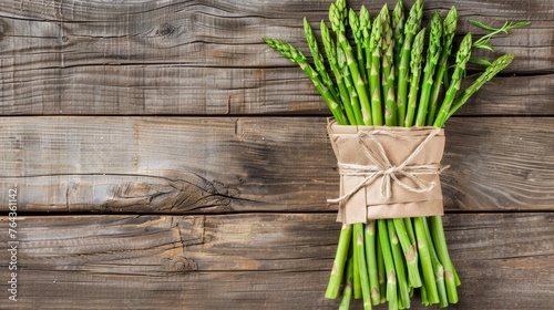 Fresh asparagus bundle on rustic wooden background