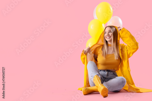Young woman in raincoat wit...