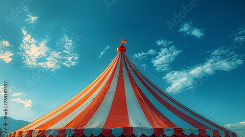 Vibrant circus tent against a blue sky