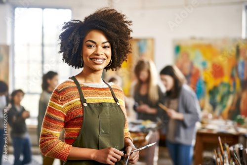An art instructor in a striped apron stands proud among her students, all deeply engaged in a light-filled studio. Concept of vibrant art education