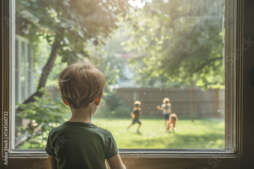 Young boy wants to play outside in the backyard with the other children photo