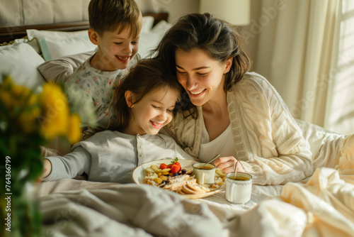 Mom gets morning breakfast in bed from her son and daughter