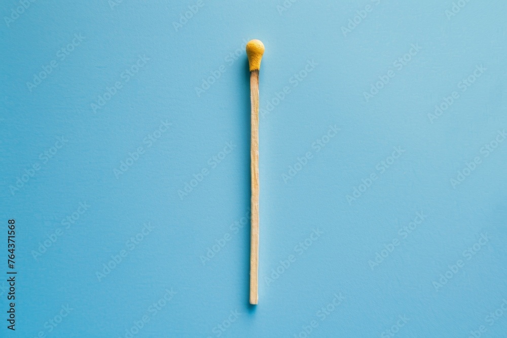 A matchstick is shown on a blue background A matchstick is shown on a blue background