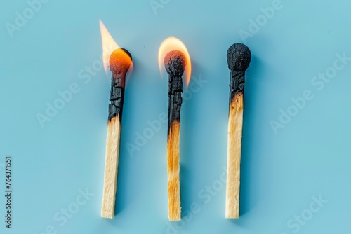 Three matchsticks are lit up and one is burning