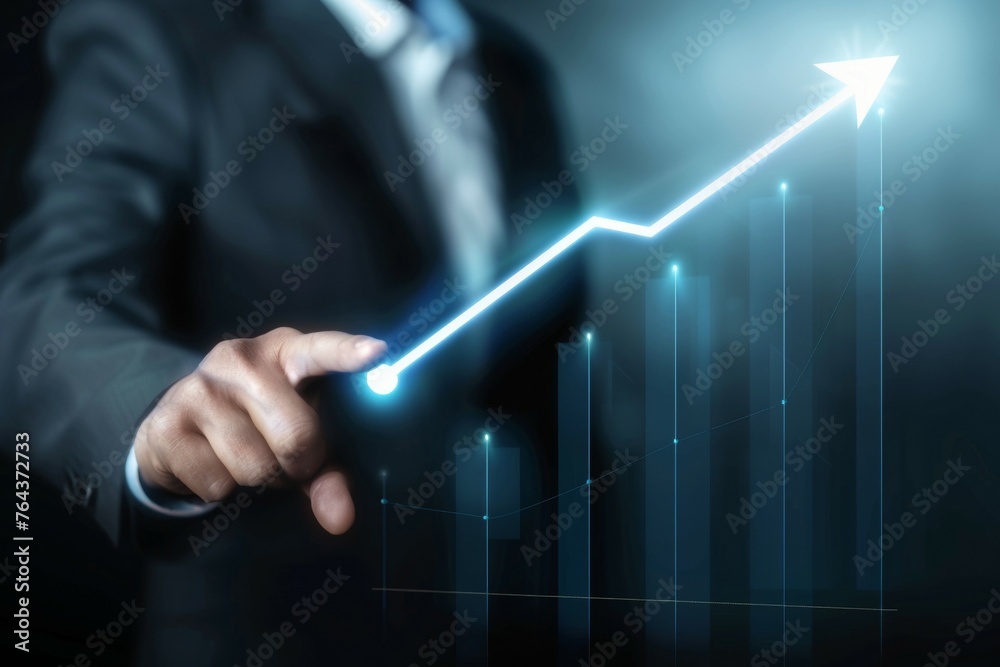 A man in a suit is pointing at a graph with a line that is rising A man in a suit is pointing at a graph with a line that is rising