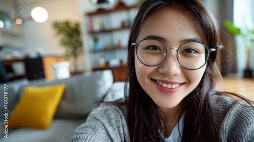 Woman is taking a selfie in her apartment photo
