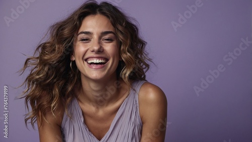 Argentinian woman in her 20s with beautiful wavy hair posing smilingly against a light purple background, studio shot, space for advertising