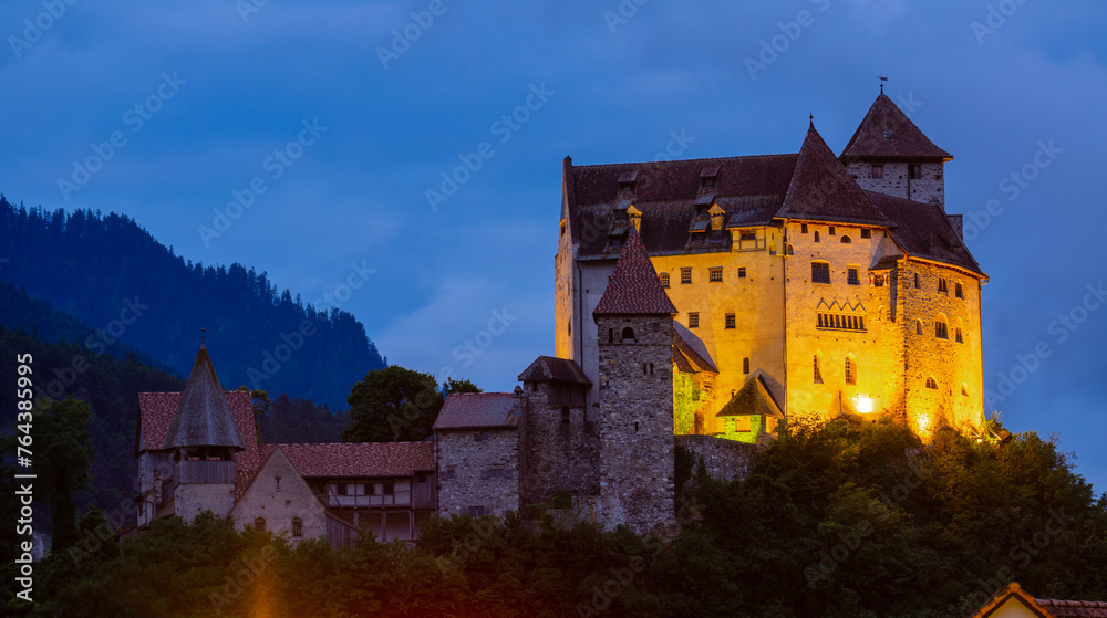 Night view of illuminated medieval Gutenberg Castle on hilltop in Balzers village on summer, Liechtenstein