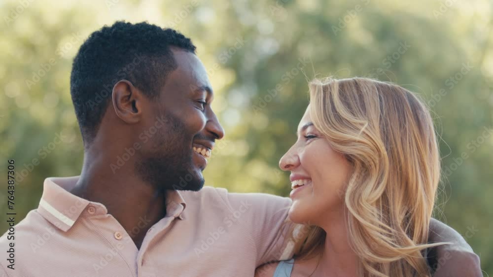 Close up portrait of couple or friends hugging outside in beautiful countryside laughing and smiling at camera - shot in slow motion Close up portrait of couple or friends hugging outside in beautiful countryside laughing and smiling at camera - shot in slow motion