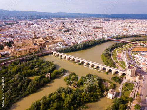 Aerial view of Historic centre of Cordoba with antique Roman Bridge over Guadalquivir river and medieval Mosque-Cathedral, Spain