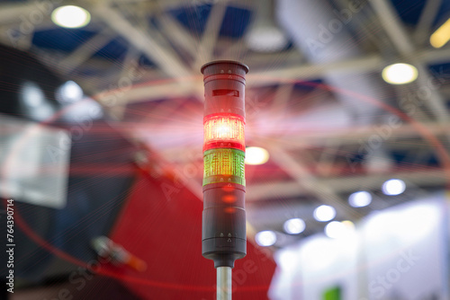 A Signal Tower. Traffic light at the machine. Red traffic light in a factory workshop. Industrial traffic light in a production workshop. Conveyor warning system