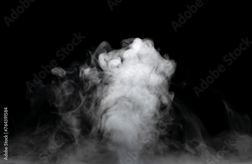 White puffs of smoke on a black background float mixing in bizarre chaotic patterns of thin threads