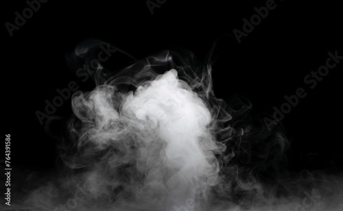 White puffs of smoke on a black background float mixing in bizarre chaotic patterns of thin threads