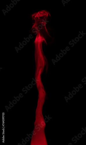 Abstract background of chaotically mixing puffs of red smoke on a dark background