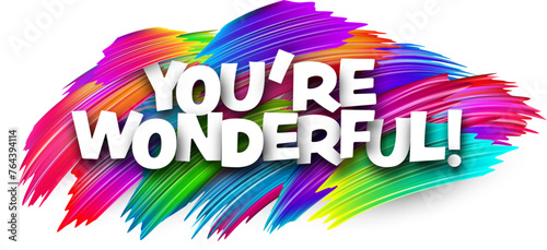 You are wonderful paper word sign with colorful spectrum paint brush strokes over white.