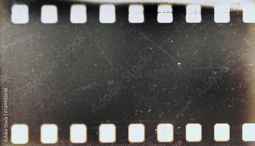 Blank grained film strip texture background with heavy grain and dust, shallow depth of field, horizontal