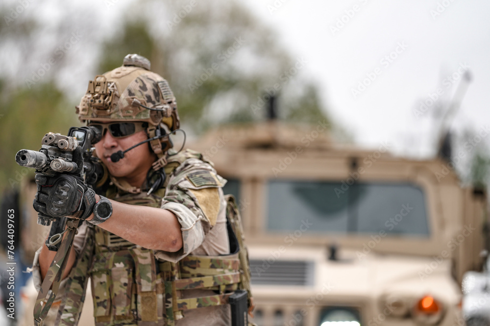 Confident soldier in full gear stands before a military vehicle, rifle in hand, showcasing readiness and strength. Confident soldier in full gear stands before a military vehicle, rifle in hand, showcasing readiness and strength.
