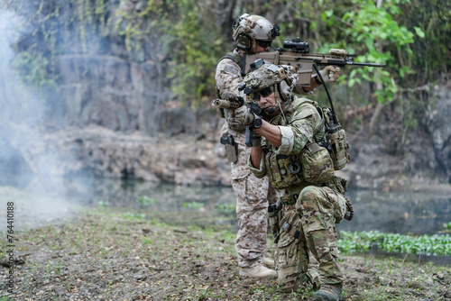 Soldiers in tactical gear aiming guns during a military exercise  showcasing teamwork and defense strategies.