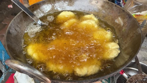 Traditional Thekua being fried in hot oil in local dhaba in Bihari Style. photo