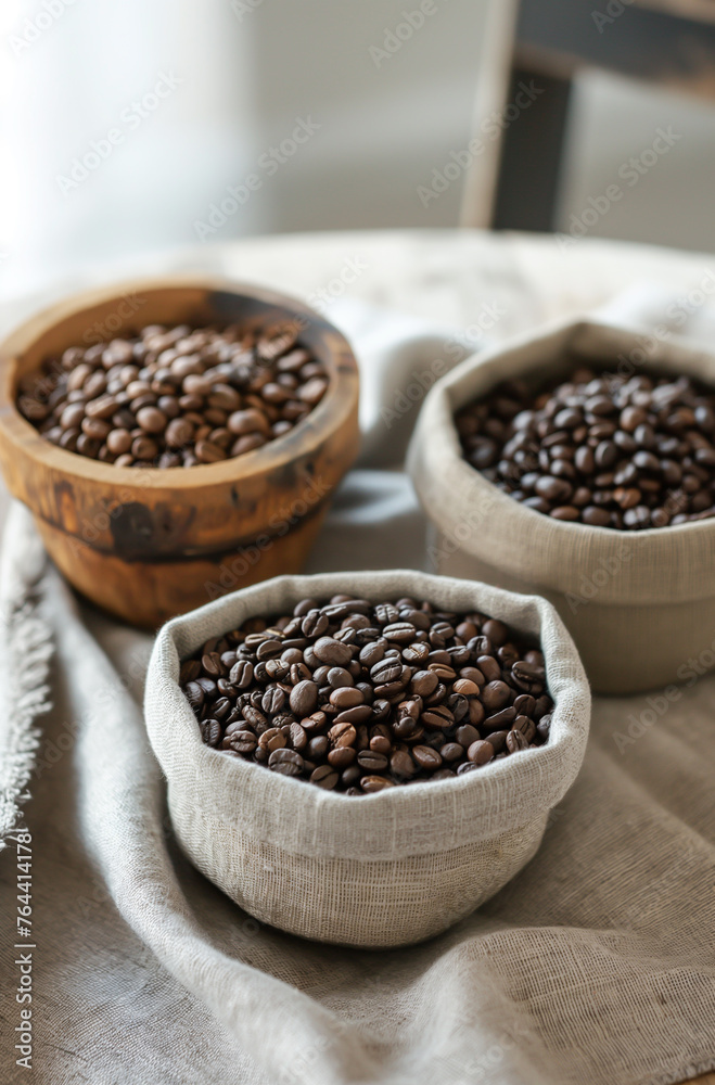 Three bowls of coffee beans are displayed on a table Three bowls of coffee beans are displayed on a table