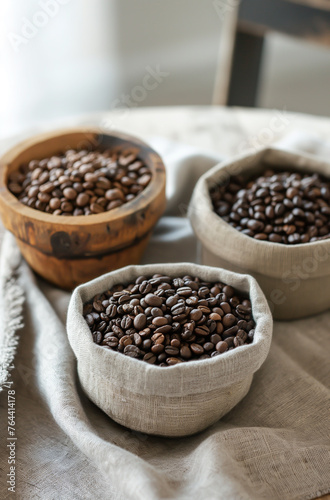 Three bowls of coffee beans are displayed on a table