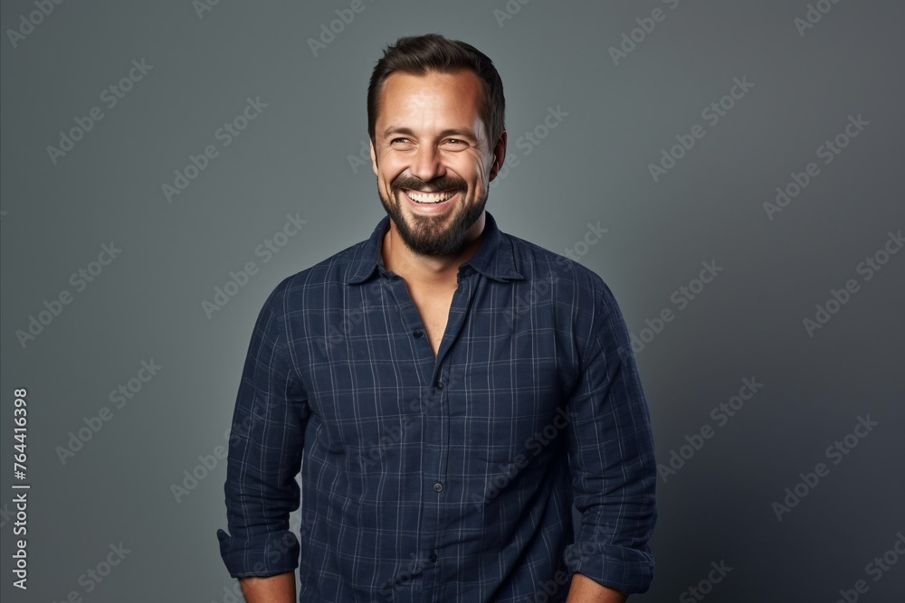 Portrait of a handsome smiling man in a blue checkered shirt. - obrazy, fototapety, plakaty 
