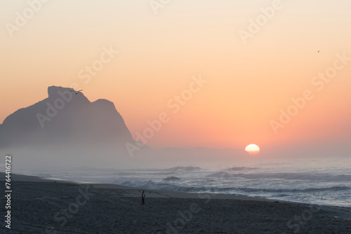 Recreio dos Bandeirantes beach at sunrise with the Pedra da Gavea mountain