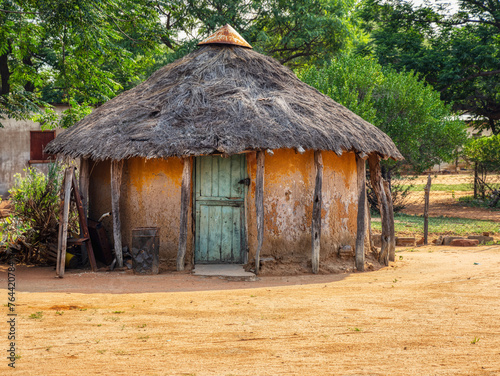 traditional rondavel in an african village in Botswana, view from the backyard photo