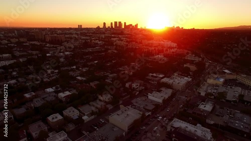 Aerial Shot Of Modern Buildings In Downtown District, Drone Flying Forward Over Residential Landscape During Sunset - West Hollywood, California photo