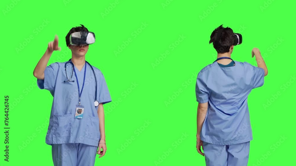 Health specialist using vr headset to examine patient diagnosis, stands against greenscreen backdrop. Nurse works with artificial intelligence virtual reality glasses, three dimensional. Camera B. Health specialist using vr headset to examine patient diagnosis, stands against greenscreen backdrop. Nurse works with artificial intelligence virtual reality glasses, three dimensional. Camera B.
