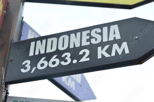 Close-up shots of directional signs pointing towards the enchanting destinations of the Indonesia photo