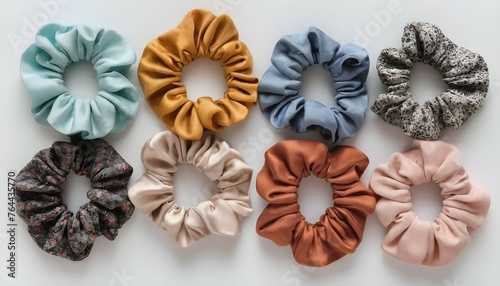 A top view of trendy hair scrunchies in various colors and fabrics, adding a playful touch to hairstyles.
