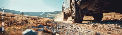 Focus on the high chassis of the SUV and its noticeable distance from the road, emphasizing the ruggedness of the vehicle photo