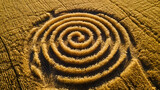 Utilize aerial perspectives to capture abstract patterns formed by agricultural crop circles, highlighting the geometric shapes