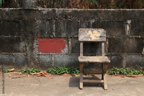 Old chair and old cement wall in the background
