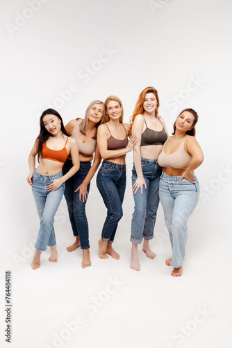 Beautiful, group of different attractive women wearing sexy bras and jeans looking at camera